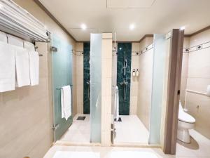 a bathroom with a shower and a toilet at Formosan Naruwan Hotel in Taitung City