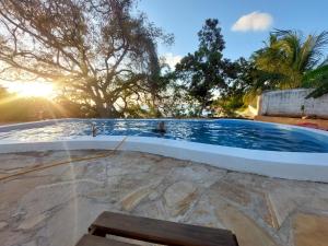 a swimming pool with a yellow hose at Shiri Beach Resort in Zanzibar City
