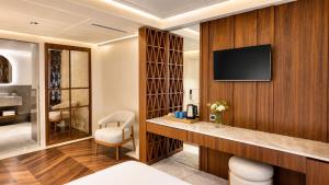 a hotel room with a television on a wall at Alaturka Mansion in Istanbul