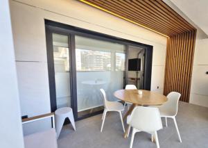 a dining room with a table and chairs and a window at BR Silgar Club in Sanxenxo