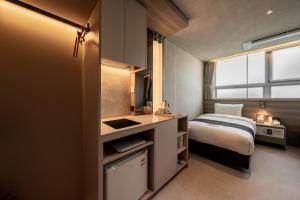 a bedroom with a bed and a sink in a room at My Me Hotel in Seoul