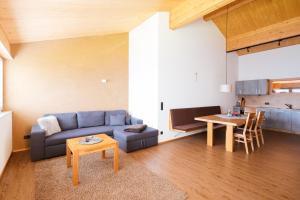 a living room with a couch and a table at Alpenpanorama Konzett Faschina in Fontanella