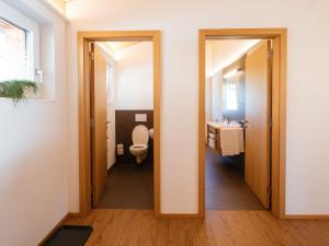 a bathroom with a toilet and a sink at Alpenpanorama Konzett Faschina in Fontanella +22 photos