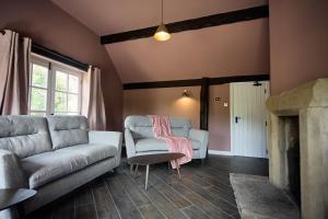 a living room with two chairs and a couch at Jasmine Cottage - Sands Farm in Wilton +12 photos