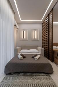 a bedroom with a large bed with two pillows on it at Elite Suite in Xanthi