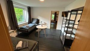 a living room with a couch and a table at Die ANS Group Cozy Apps in Detmold