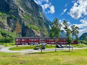 a red building in front of a mountain at Trædal Hotel in Sunndalsøra