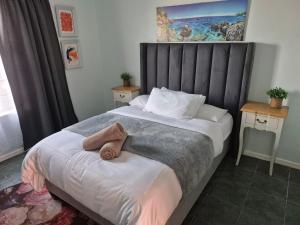 a bedroom with a bed with a towel on it at Silver’s Rest Beach House in Clareport