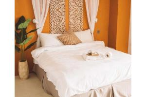 a bed with a headboard with a plate of food on it at Marian Palazz Hotel in Baguio