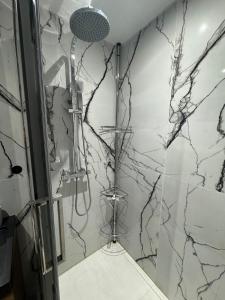 a bathroom with a shower with marble walls at ღ L'Urban Gare - T3 Cosy Parking & Wifi in Douai +23 photos