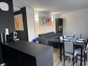 a living room with a table and a couch at ღ L'Urban Gare - T3 Cosy Parking & Wifi in Douai