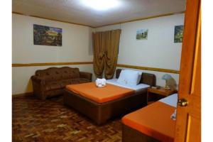 a room with a bed and a couch in a room at Marian Palazz Hotel in Baguio