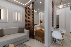 a living room with a bed and a couch at Elite Suite in Xanthi