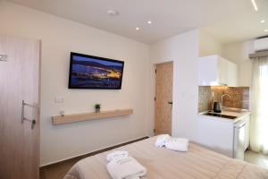 a bedroom with a bed with two towels on it at Villa Kostas Sarti in Sarti