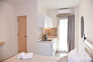 a white room with a bed and a kitchen at Villa Kostas Sarti in Sarti +59 photos