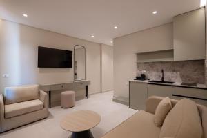 a living room with a couch and a table and a kitchen at Marea Suites Borsh in Borsh