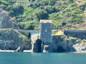a bridge over a body of water with a lighthouse at Vista Isole Eolie in Piraino +17 photos