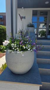 a large stone planter with flowers on the side of a building at Vila Ieva in Palanga