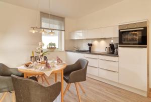 a kitchen with a table and chairs in a kitchen at Ferienweingut Port in Bernkastel-Kues