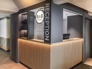 an office lobby with a sign that reads big smiles at B&B HOTEL Düren in Düren - Eifel +18 photos