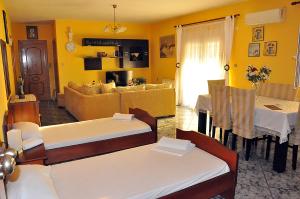 a living room with two beds and a dining room at Studios Kostas & Despina in Lidia