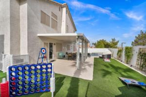 a backyard with a large house with a playground at Vegas Haven Pool Spa Game Room in Las Vegas