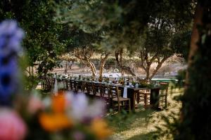 a long table with people sitting at it at Arbora Olea Luxury Villas in Skaleta +42 photos