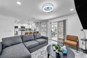 a living room with a couch and a table at Vegas Haven Pool Spa Game Room in Las Vegas