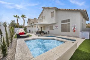 a backyard with a pool and a house at Vegas Haven Pool Spa Game Room in Las Vegas