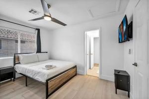 a bedroom with a bed and a ceiling fan at Vegas Haven Pool Spa Game Room in Las Vegas +63 photos