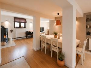 a dining room and living room with a table and chairs at Dom Wakacyjny Brenna in Brenna
