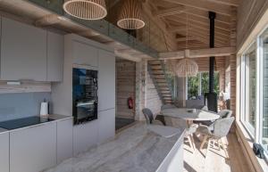 a kitchen and dining room with a table and chairs at Sommarbukt Nordlys - Private Arctic Retreat near Tromsø in Tromsø