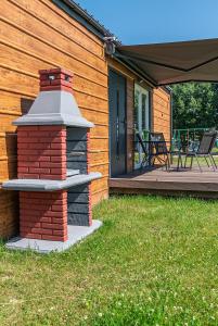 a brick fireplace on the side of a house at DOMKI#ENERGY Zator in Przeciszów
