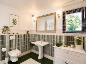 a bathroom with a sink and a toilet and a mirror at Dom Wakacyjny Brenna in Brenna +48 photos
