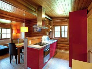 a kitchen with a stove and a table in a room at Chalet in the Wilder Kaiser ski area in Tyrol in Wörgl