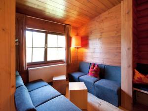 a living room with two blue couches and a window at Chalet in the Wilder Kaiser ski area in Tyrol in Wörgl