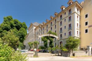 a large building with a sign for a hotel at Studio Le Splendid 3 Hôtel étoiles in Allevard