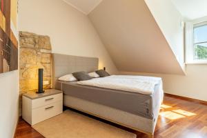 a bedroom with a bed and a stone wall at Ferienvilla Bad Schandau in Bad Schandau