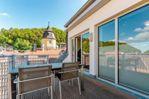 a balcony with a table and chairs and a view at Ferienvilla Bad Schandau in Bad Schandau