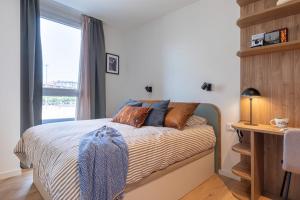 a bedroom with a bed with a window and a desk at Be Casa Barakaldo in Barakaldo
