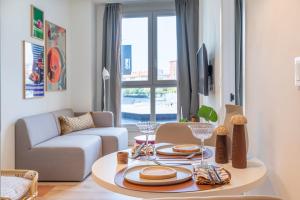 a living room with a table and a couch at Be Casa Barakaldo in Barakaldo