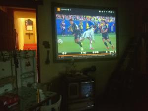 a television screen with a soccer game on it at Krasberry Ježev brlog in Komen