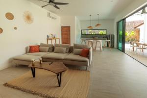 a living room with a couch and a table at Samma Villas - Ruby Villa - 2 BDR & private pool in Ko Phangan