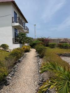a gravel road in front of a house at Nyota Apartment in Nungwi
