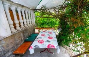 a bench sitting next to a wall with a table at Sea Mona in Tivat