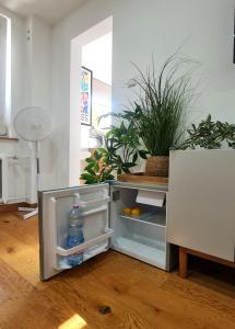 an open refrigerator with a bottle of water in it at Apartament Tęczowy Tukan -1 piętro in Kwidzyn