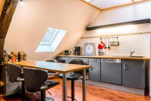 a kitchen with a wooden table and chairs at Mirabeau in Le Mont-Dore