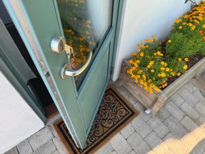 an open door with a bunch of yellow flowers at Tiny Guesthouse in Nakskov