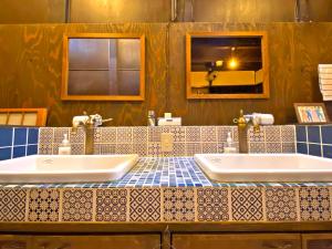 a bathroom with two sinks and a blue and white tiled counter at Guesthouse Kioto in Kyoto +78 photos