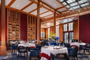 a dining room with tables and chairs and a glass ceiling at The Venetian Macao in Macau